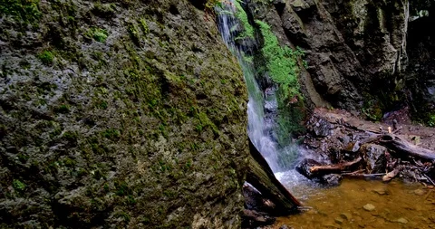 Waterfall splash, spring water as it falls and dribbles on rocks covered Stock Footage 125773370