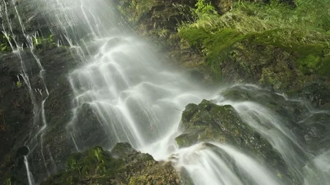 Waterfall splashing into a cascade of rocks. Stock Footage 212561339