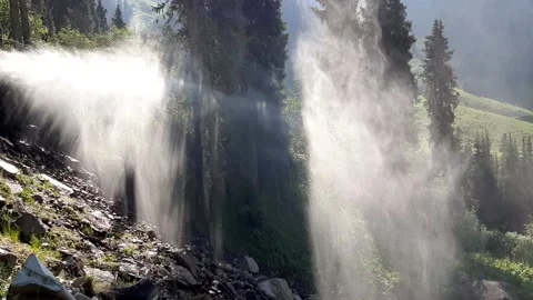 Waterfall spraying down forest hill Stock Footage 195392564