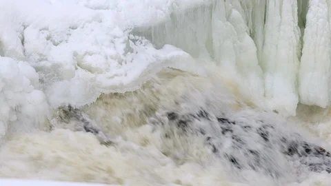 Waterfall, spring river with ice and snow Stock Footage 105638644
