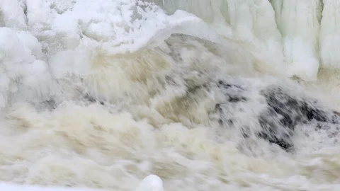 Waterfall, spring river with ice and snow Stock Footage 105642501