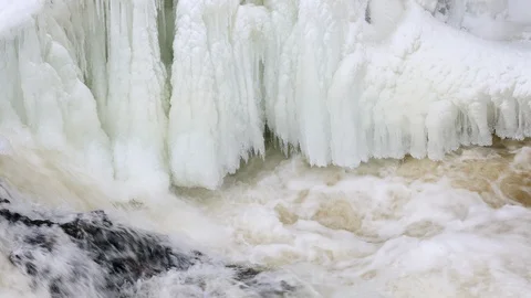 Waterfall, spring river with ice and snow Stock Footage 105698774