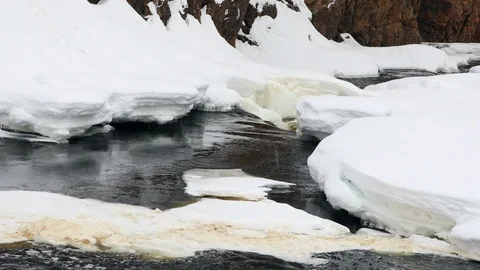 Waterfall, spring river with ice and snow Stock Footage 105699415