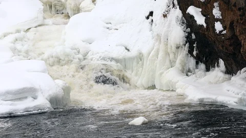 Waterfall, spring river with ice and snow Stock Footage 106011851