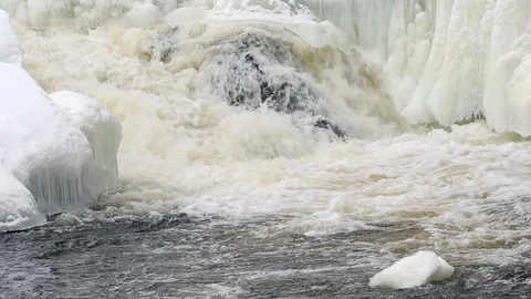 Waterfall, spring river with ice and snow Stock Footage 106011930