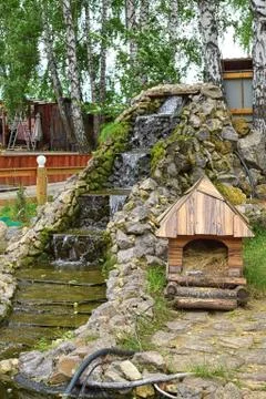 Waterfall with steps with small house in park Stock Photos