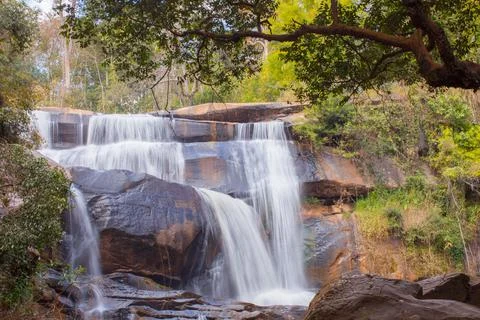 Waterfall with stone foreground in forest Stock Photos