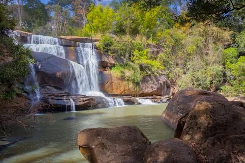 Waterfall with stone foreground in forest Stock Photos
