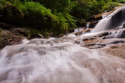 Waterfall on stone in forest Stock Photos