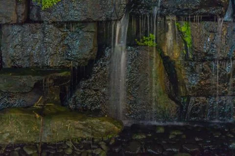 Waterfall from stone wall Stock Photos