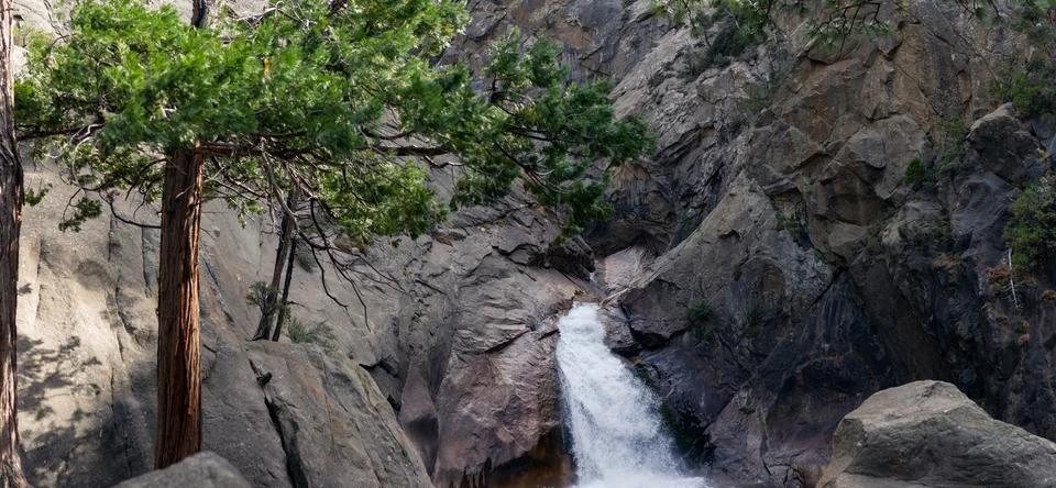 Waterfall in stone walls fall down to natural pool with clear water in nati.. Stock Photos