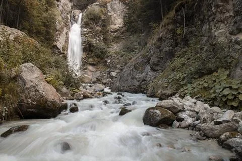 Waterfall stream flowing through rocky forest landscape Stock Photos