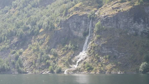 A waterfall stream to a mountain lake in the rain. Stock Footage 278045181