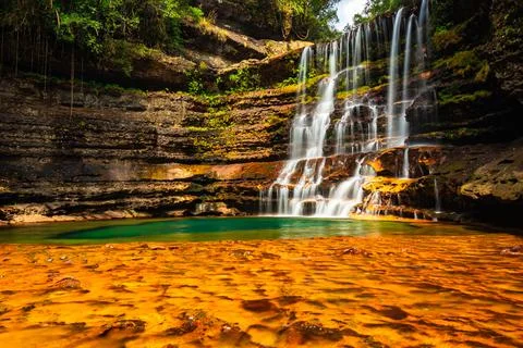 Waterfall streams falling from mountain with blurred water surface at morning 写真素材