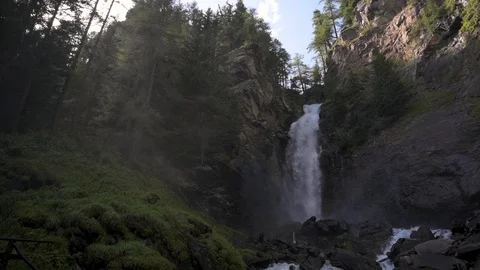 Waterfall with sun rays whimsical mountain landscape Stock Footage 128303006