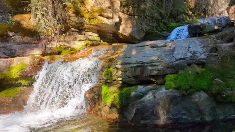 Waterfall in sunlight with half the frame in a shadow Stock Footage 211424167