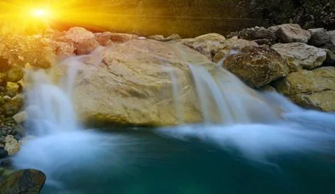 Waterfall on sunset background 스톡 사진