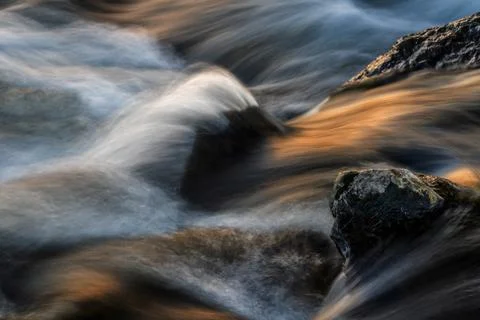 Waterfall at sunset, long exposure. Stock Photos