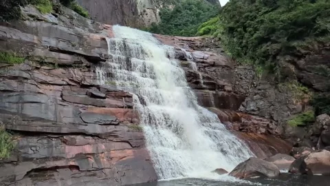 This waterfall is surrounded by pristine rainforest Stock Footage 340266977