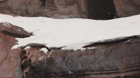 Waterfall at the Temple of Sinawava with snow chunks falling at half speed Stock Footage 234662259