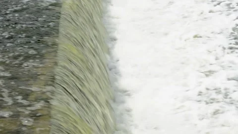 Waterfall through a dam on the river,close up. Video stock 200846478