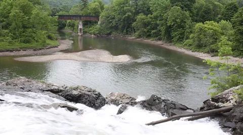 Waterfall with train bridge in distance Stock Footage 39540638