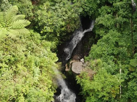 Waterfall on tropical mountain, Java, Indonesia. Stock Photos