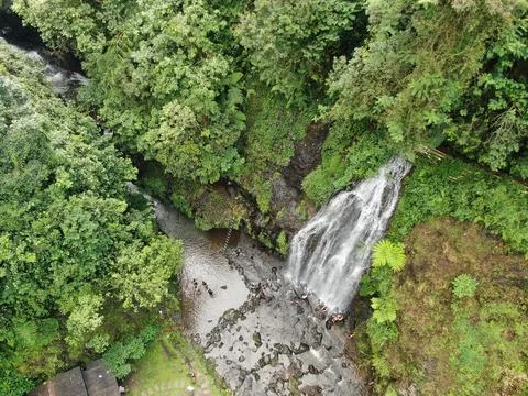 Waterfall on tropical mountain, Java, Indonesia. Stock Photos