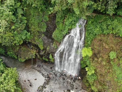Waterfall on tropical mountain, Java, Indonesia. Stock Photos
