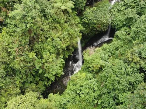 Waterfall on tropical mountain, Java, Indonesia. Stock Photos