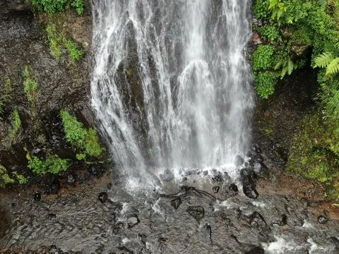 Waterfall on tropical mountain, Java, Indonesia. Stock Photos