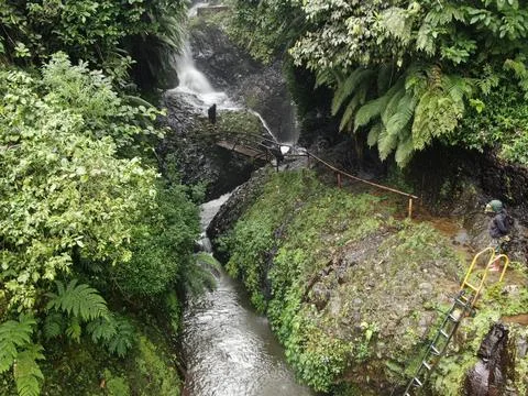 Waterfall on tropical mountain, Java, Indonesia. Stock Photos