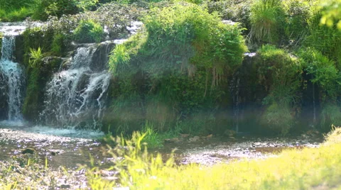 Waterfall on a tufa dam, River Lathkill, Peak District, England. 4K camera pan. Stock-Footage 64403060