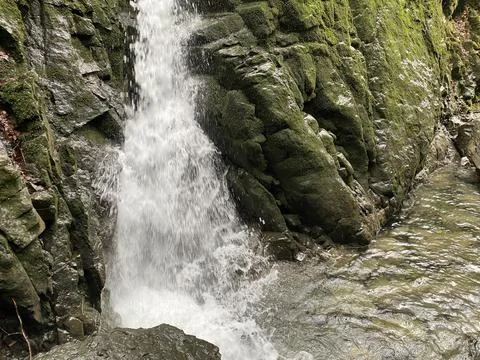 A waterfall under a cave and the source Hundsloch (Hundslochquelle) Stock Photos