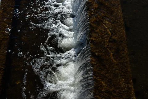 Waterfall view from above. Falling water, foam from the waterfall. Winter Stock Photos