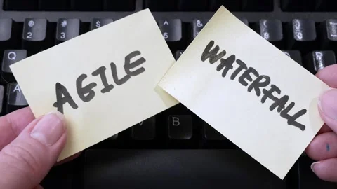 Waterfall vs agile paper task on black keyboard background, software development Видео 258110555