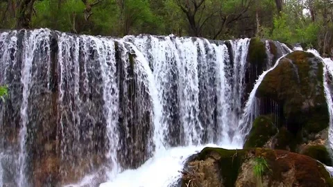 The waterfall wall gives birth to a roaring river Stock Footage