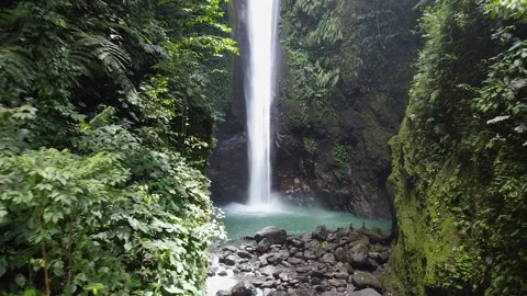 The waterfall, a water stream, falls from a steep cliff, its peculiarity is the Stock Footage 196136050