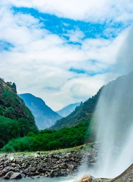 Waterfall white water stream falling from mountains with valley at day long e 스톡 사진