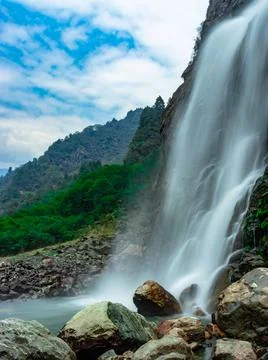 Waterfall white water stream falling from mountains with valley at day long e 스톡 사진