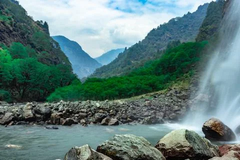 Waterfall white water stream falling from mountains with valley at day long e 스톡 사진