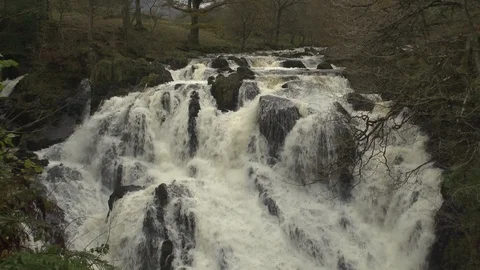 Waterfall. Wide shot with tilt down to river in slow motion Stock Footage 86830081