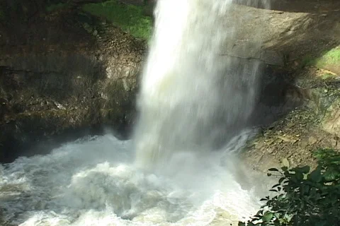 Waterfall- widens out from CU of bottom splashing Stock Footage 125717783