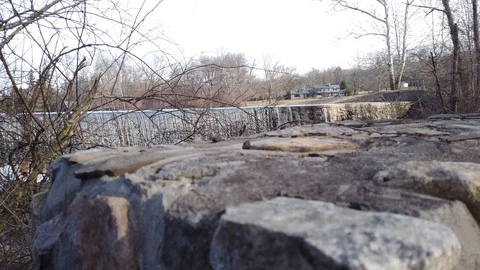 Waterfall in Winter Beyond an Old Brick Wall Stock Footage 101665428