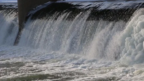 Waterfall in winter on dam. rapid strong flow of water falls down. Video stock 87242175