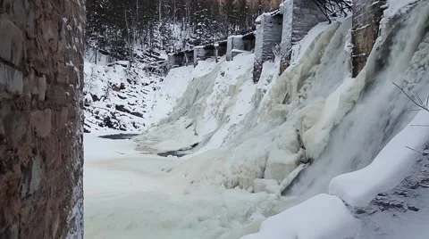 Waterfall in the winter forest. Old micro hydro power plant Stock Footage 64464849