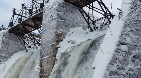 Waterfall in the winter forest. Old micro hydro power plant Stock-Footage 64464876