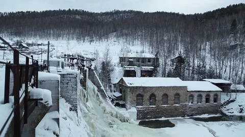 Waterfall in the winter forest. Old micro hydro power plant Stock Footage 64465948