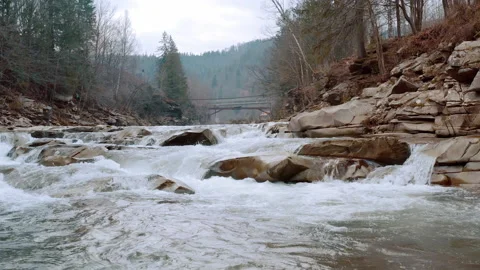 Waterfall in the Winter. Rapid Flow of Water from a Mountain Creek Stock Footage 147186947