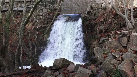 A waterfall in the woods between trees and rocks Stock Footage 120997037